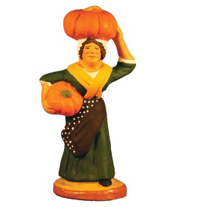 image: Woman carrying pumpkins