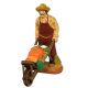 image: Gardener with vegetables on wheelbarrow